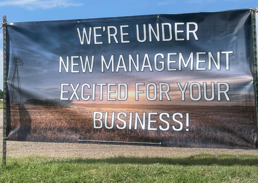 Banner that reads WE'RE UNDER NEW MANAGEMENT EXCITED FOR YOUR BUSINESS!